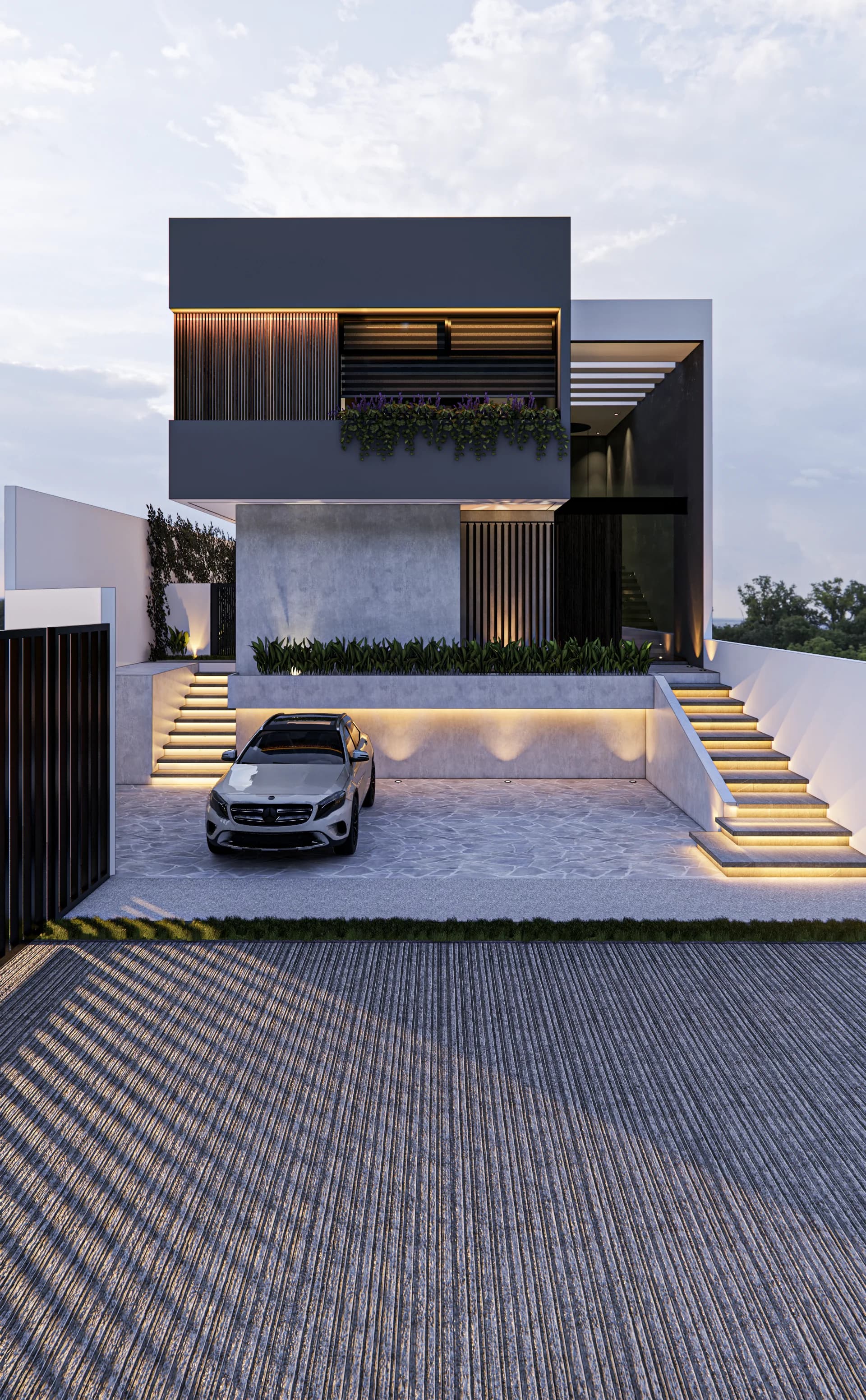 Fachada de Casa Grillos al anochecer, con escalinata iluminada y cochera empedrada